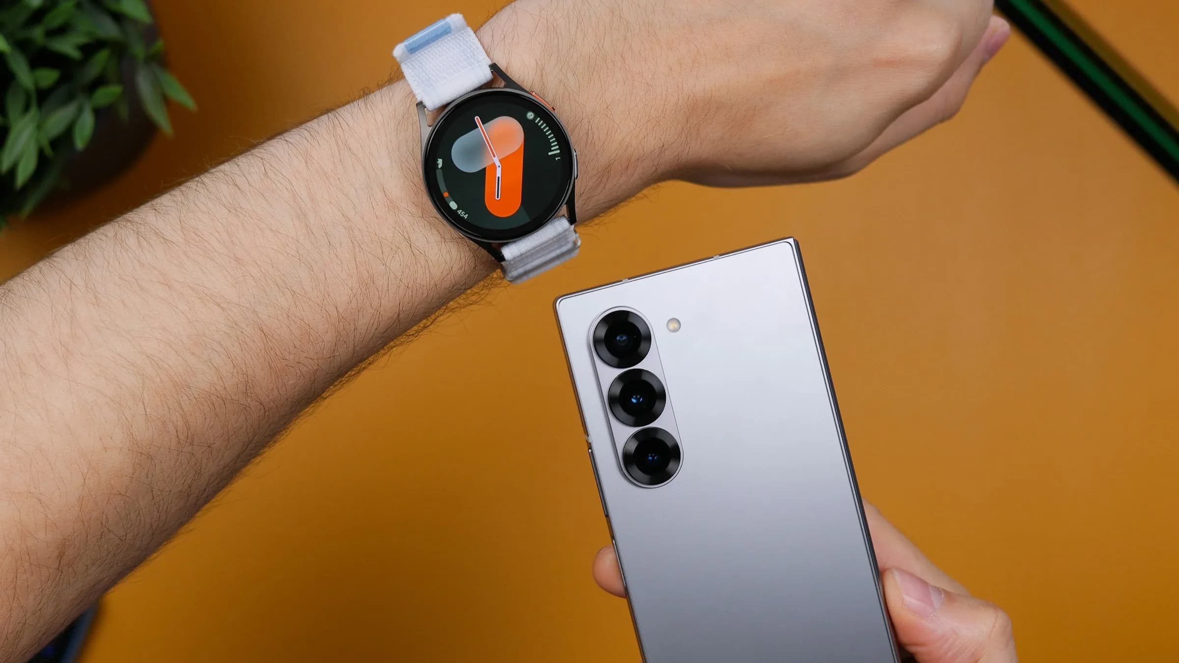 Wear OS watch on a wrist next to an Android phone